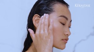 Mulher a lavar o cabelo com produtos da gama Symbiose da Kérastase