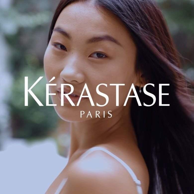 Mulher como fundo e logo da kérastase centrado em letras grandes 